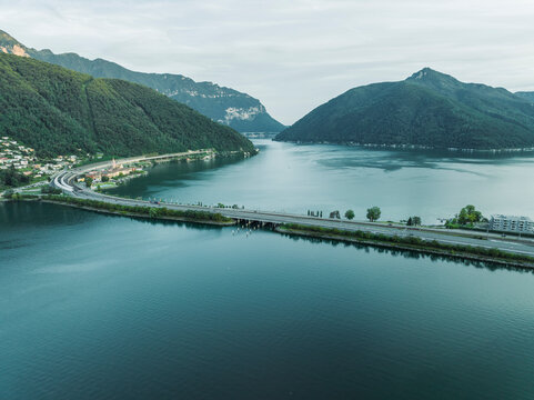 Aerial view of a road crossing the Lugano lake at sunset, Melide, Ticino, Switzerland.
