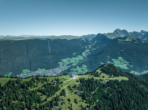 Aerial view of the mountain ridge at the top of Alpe di Siusi (Seiser Alm) on the Dolomites mountains with Secede peak in background, Ortisei, Trentino, South Tyrol in Northern Italy.
