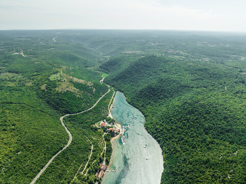 Aerial view of a road on the hills following the Limski Fjord (Canal di Leme) in Sveti Lovrec, Istria, Croatia.