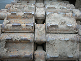 Close-up front view of a tank track with stuck pieces of soil