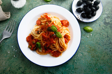 Traditional pasta with tomatoes, olives and anchovy