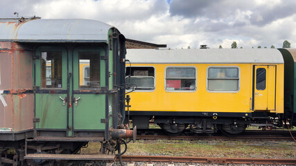 old passenger cars of the east german Reichsbahn are waiting to be restored.