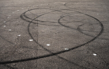 skid marks on a road surface. Circular tire marks left by drivers doing doughnuts