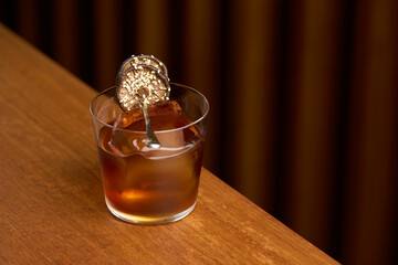 Rum cocktail glass with mushrooms sesame and ice cube