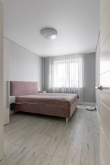Fototapeta na wymiar A modern room in a new apartment with a minimum set of furniture