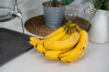 A bunch of fresh banana in a modern kitchen.