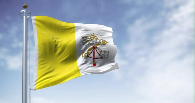 Flag of Vatican City waving in the wind on a clear day
