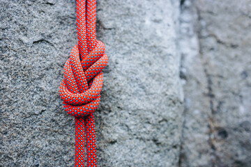 eight climbing knot with colorful rope on rocky background