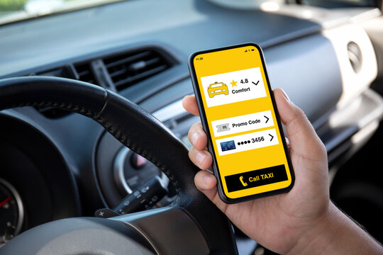 Man Hand Holding Phone With Taxi Call Application In Car