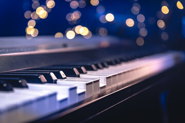 Piano keys close-up on a blurred background with bokeh.