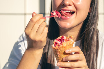 Portrait of happy caucasian brunette woman, eating ice-cream cone.