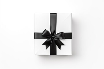 close up of white gift box with black bow on white background