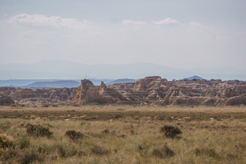 Fototapeta na wymiar Rock formations at desert landscape of the arid plateau of the Bardenas Reales, Arguedas, Navarra, Spain