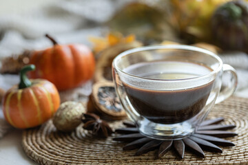 Autumn composition with a cup of hot drink close-up.