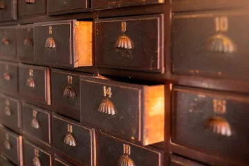 Zelfklevend Fotobehang Vintage background of old wooden drawers pattern texture. Old wooden textured drawers background in chinese or thai herbal medicine shop. © Koonsiri
