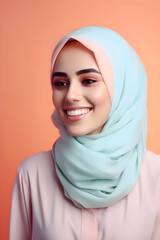 Portrait of a beautiful young Muslim woman with hijab on color background, closeup, smile, with copyspace, for banner background.