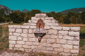 Ancient stone fountain in the countryside, Molise Italy - 655780138