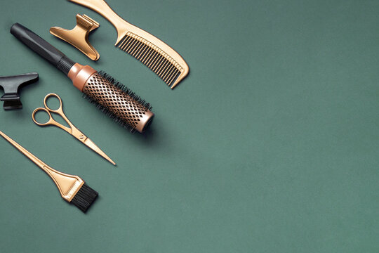 Golden hairdressing tools scissors combs on green background. Horizontal template with hair salon accessories and copy space. - Powered by Adobe