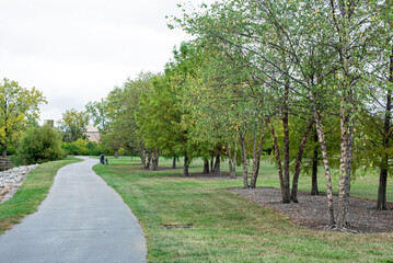 Tree Lined Curving Paved Bike Path in Early Fall