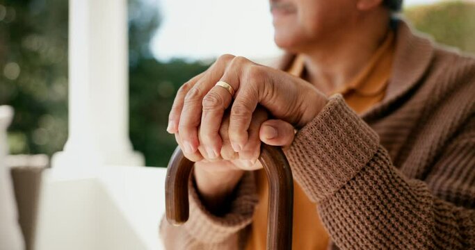 Man, mature and holding a walking stick closeup, relax and sitting outdoors for retirement, widower and peace. Old senior person with disability and arthritis by injury, balance and support with cane