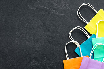 Paper shopping bags on a dark background, top view.