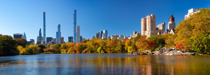 Panoramic view of The Lake in Central Park with Billionaires' Row skyscrapers and Upper West Side buildings. Autumn morning in the Central Park West Historic District. Manhattan, New York City