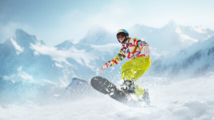 Young girl in sportswear sliding on snowboard over snowy mountains background. Winter activity....