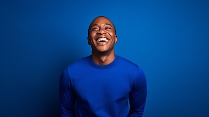 handsome young man, smiling and laughing, wearing vibrant sweater