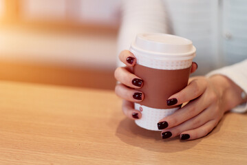 Woman holding a mug with coffee. Coffee rituals. Concept of the day beginning before getting into...