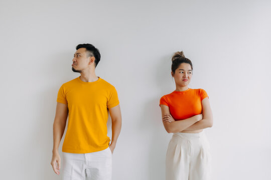 Asian Thai couple lover wear yellow and orange, standing and getting mad angry, sulking upset isolated on white background. 