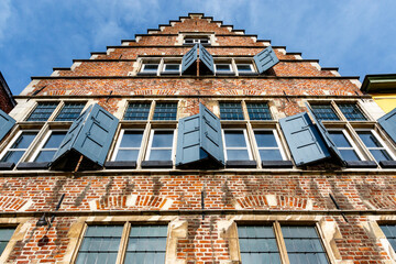 Facade of an old house with blue shutters, Ghent, Flanders, Belgium