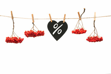 autumn background with red rowan berries and a sheet of writing hanging on a rope, autumn discounts...
