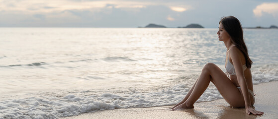 Fototapeta na wymiar Beautiful Woman in Bikini Enjoying life on Tropical beach. Female on Sandy Beach Relaxing. Summer Vacation time.