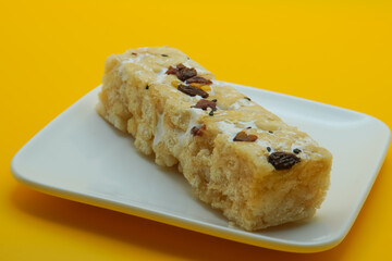 Chinese traditional dessert - Caramel treats, Sachima. yellow background
