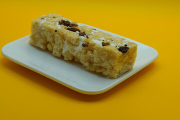 Chinese traditional dessert - Caramel treats, Sachima. yellow background