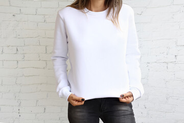 Woman wearing White sweatshirt mockup with copy space. with natural blur stone wall. Sweatshirt...