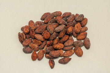 Organic raw cacao beans on white
