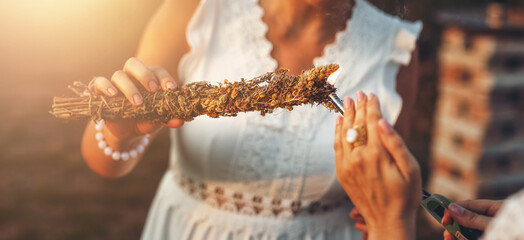 incense in a woman hand, ceremony space.