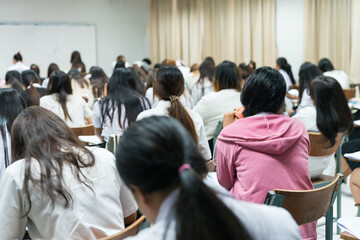 Asian college students concentrate on doing examinations in the classroom. Education stock photo - obrazy, fototapety, plakaty