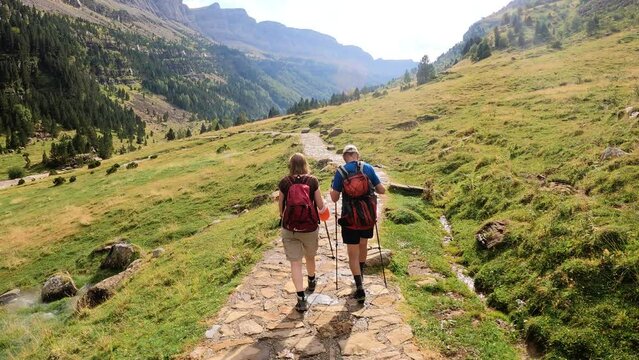 Hikers walking down trail in Ordesa natural park, Spain