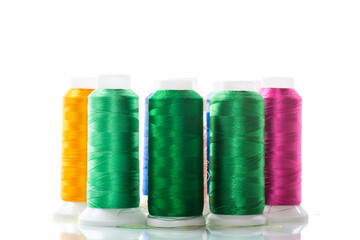 set of different color sewing threads,on white background.