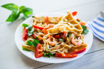 Fried simple omelet with shrimp and vegetables in a plate.