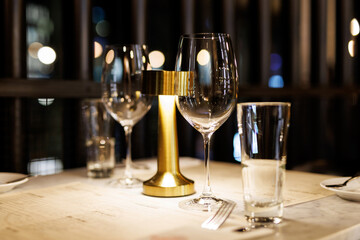 Wine glasses on a table in a restaurant awaiting guests.