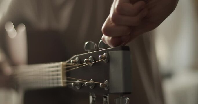 Cropped male musician playing guitar