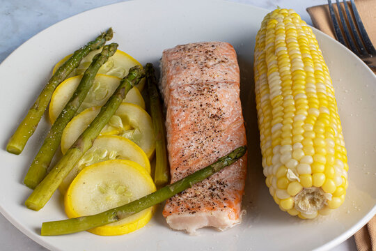 baked slamon top wit seasoning  with vegetables,