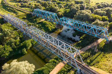 Metal structure of railway bridges over the river, aerial view
