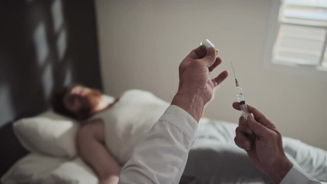 Selective focus shot of unrecognizable doctor working in mental health hospital filling syringe with sedative