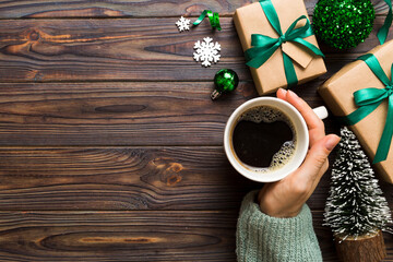 Woman holding cup of coffee. Woman hands holding a mug with hot coffee. Winter and Christmas time concept