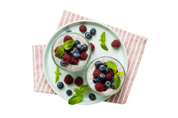 Healthy breakfast or morning with chia seeds vanilla pudding raspberry and blueberry berries on table background, vegetarian food, diet and health concept. Chia pudding with raspberry and blueberry