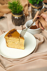 Salted Caramel Blondie cake slice include chocolate cream, sugar with fork, cup of coffee and pot served plate isolated on napkin side view of cafe food